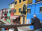 Burano at
                              its best, man and dog on bridge